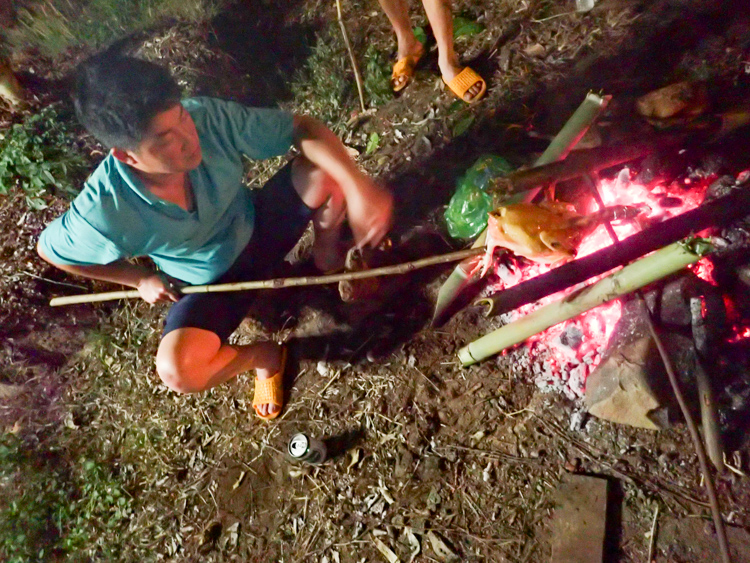 Our Easy Rider Vietnam guide cooking chicken on fire
